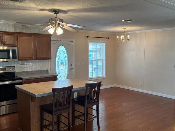 a view of a dining room with furniture and chandelier