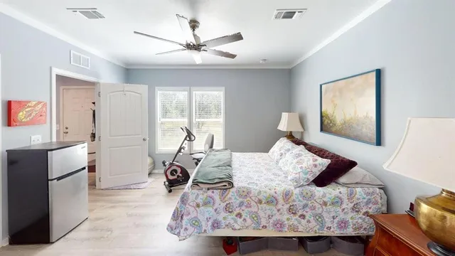 a bedroom with a bed and wooden floor