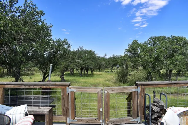 a view of a deck with mountain view and a garden