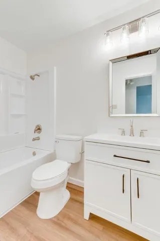 a bathroom with a sink toilet a mirror and shower