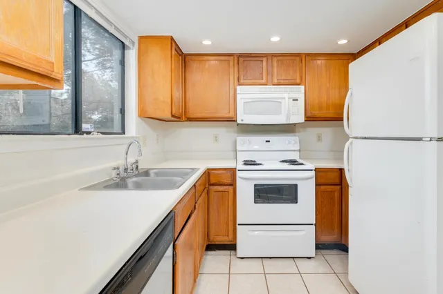 an empty room with a ceiling fan and a window