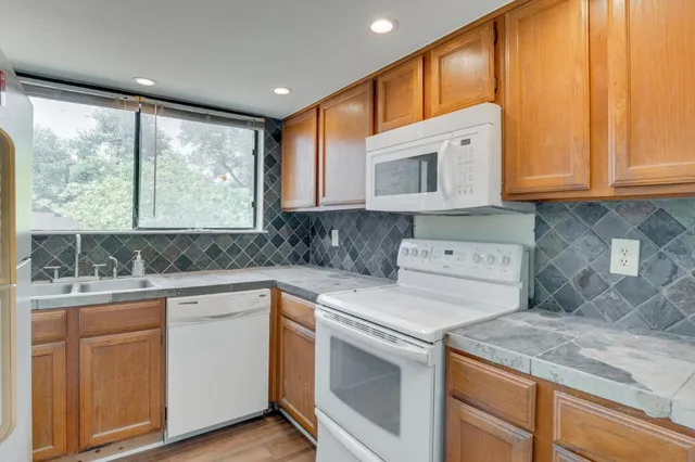 a kitchen with a sink stove and cabinets