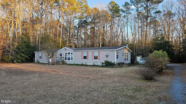 a house that has a tree in front of it