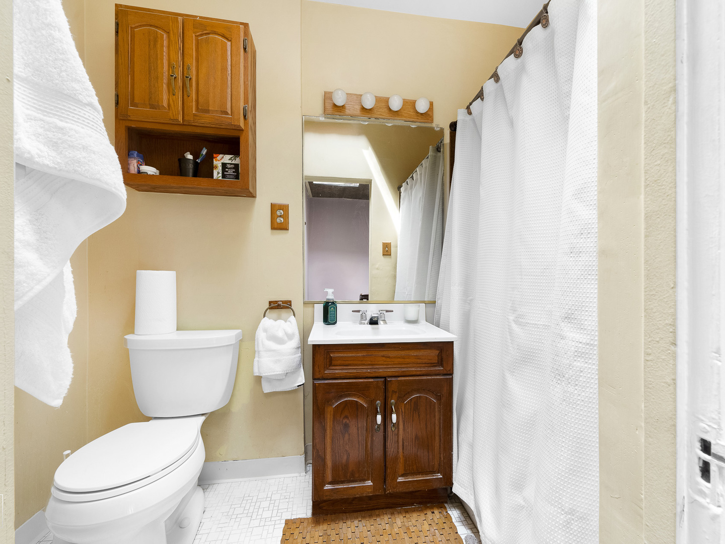 11349 South St Lawrence Avenue, Unit ROWHSE Chicago, IL 60628 - Photo 12 of 22 a bathroom with a sink a toilet and a mirror