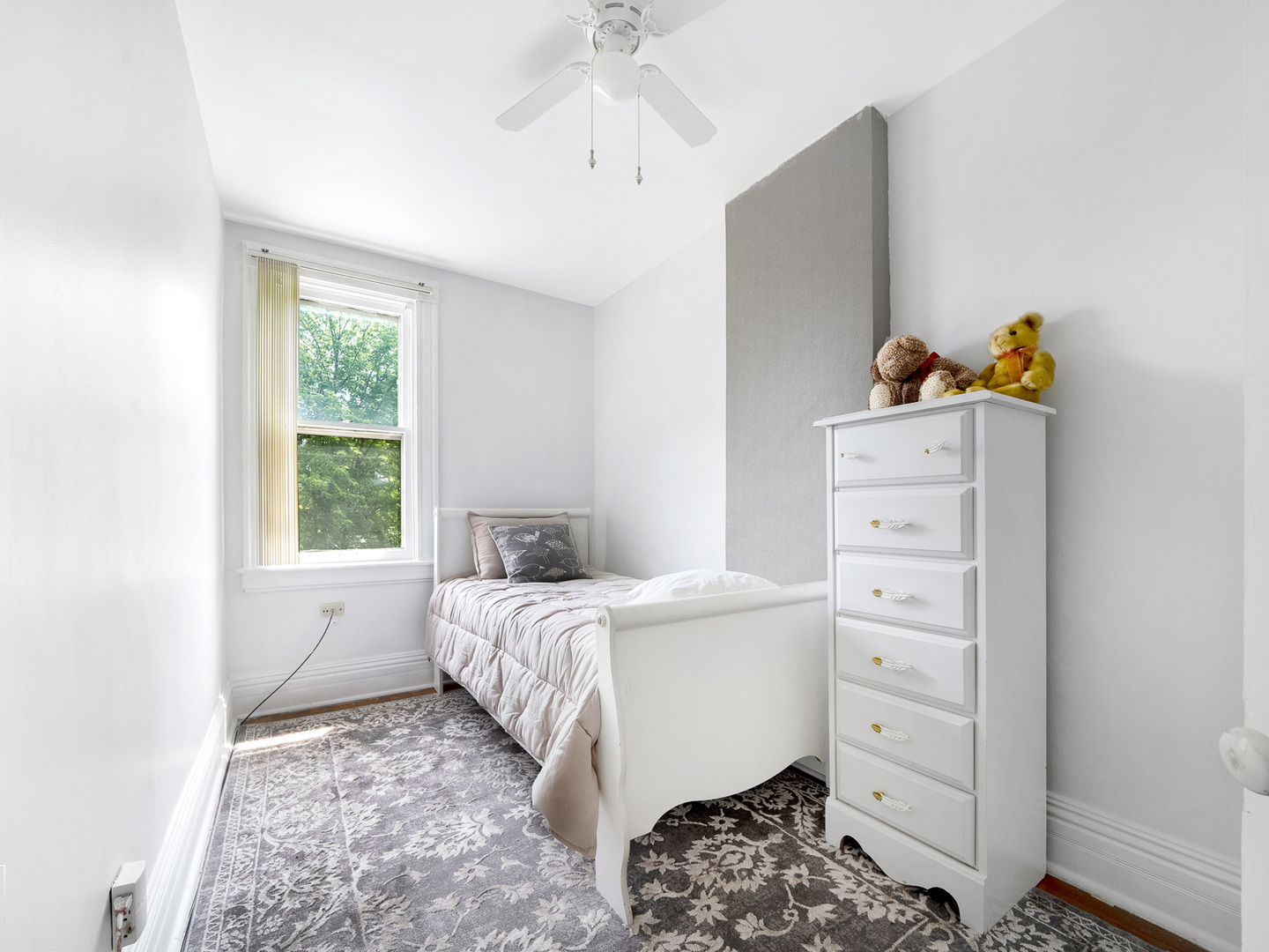 11349 South St Lawrence Avenue, Unit ROWHSE Chicago, IL 60628 - Photo 18 of 22 a bedroom with a bed and a window