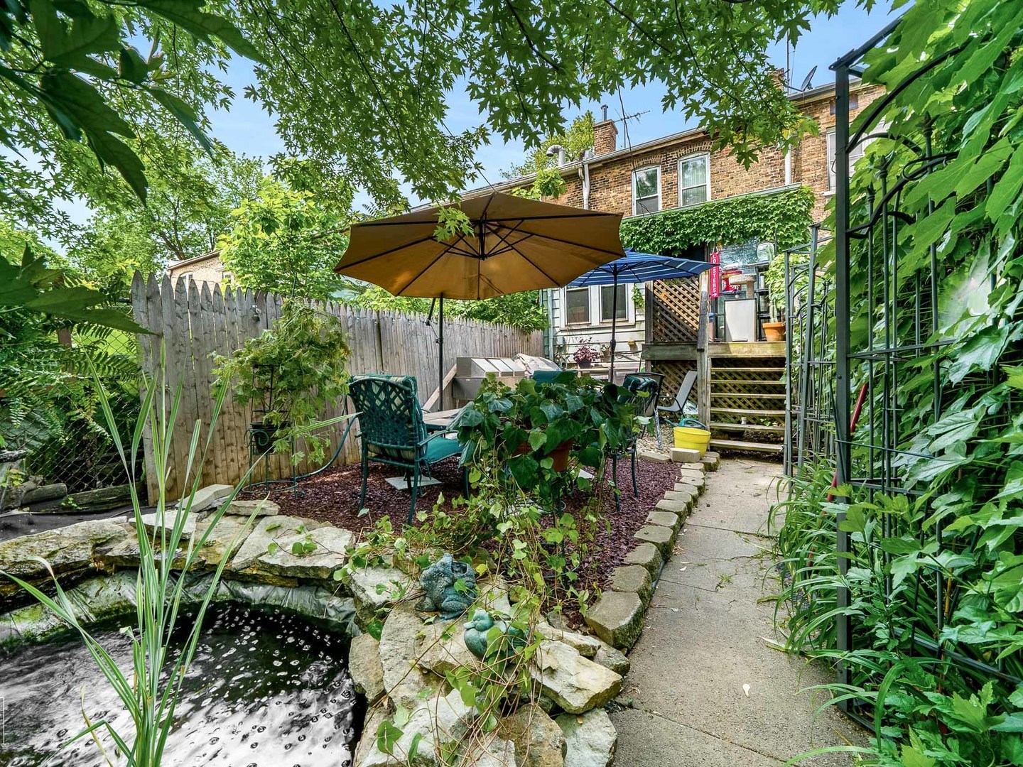 11349 South St Lawrence Avenue, Unit ROWHSE Chicago, IL 60628 - Photo 19 of 22 an outdoor view of patio with umbrella