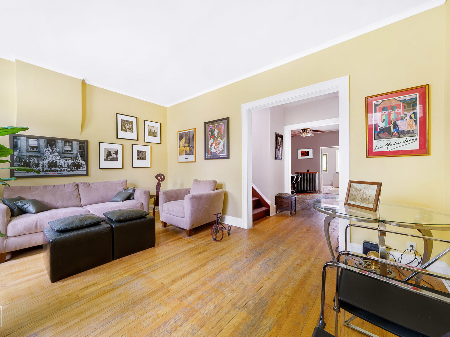 11349 South St Lawrence Avenue, Unit ROWHSE Chicago, IL 60628 - Photo 8 of 22 a living room with furniture a flat screen tv and a wall painting