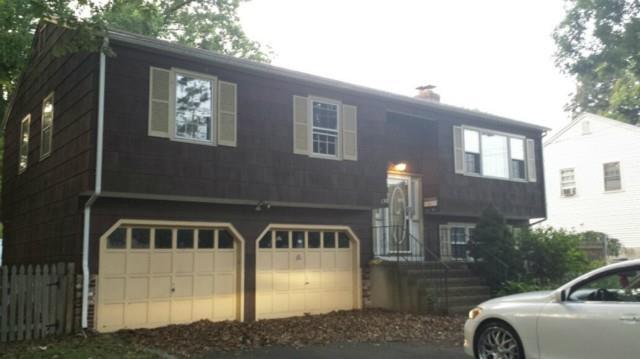 a front view of a house with parking