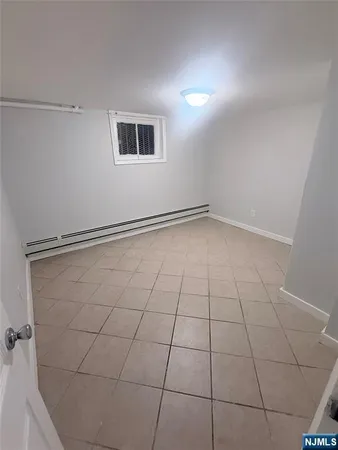 a view of a room with an empty space and a window