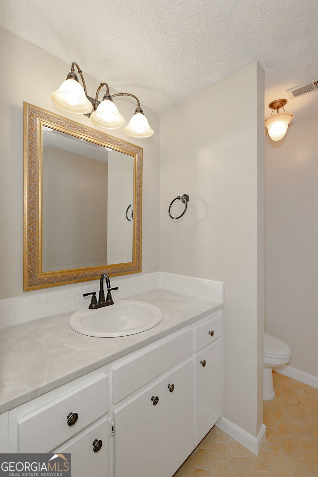 6101 River Road, Unit 2 Columbus, GA 31904 - Photo 12 of 27 a bathroom with a sink and a mirror