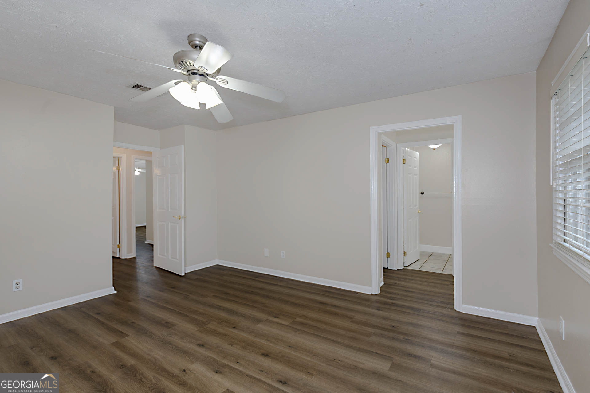 6101 River Road, Unit 2 Columbus, GA 31904 - Photo 19 of 27 a view of an empty room with wooden floor and a window