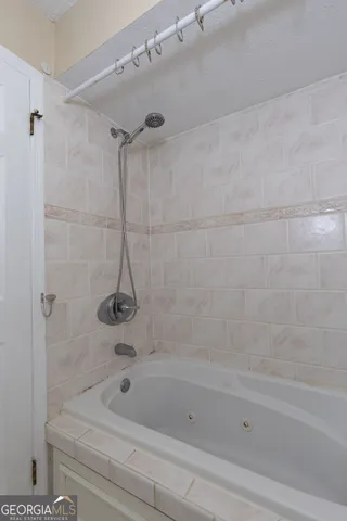 a bathroom with a bathtub and a shower