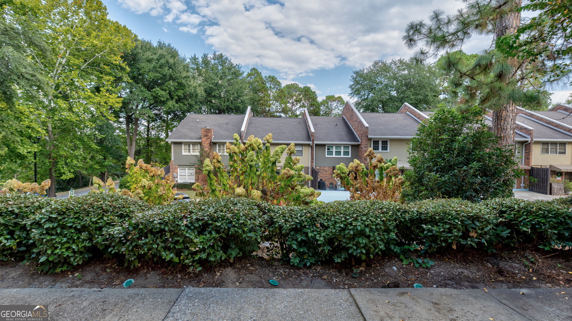 6101 River Road, Unit 2 Columbus, GA 31904 - Photo 23 of 27 an aerial view of a residential apartment building with a yard and plants