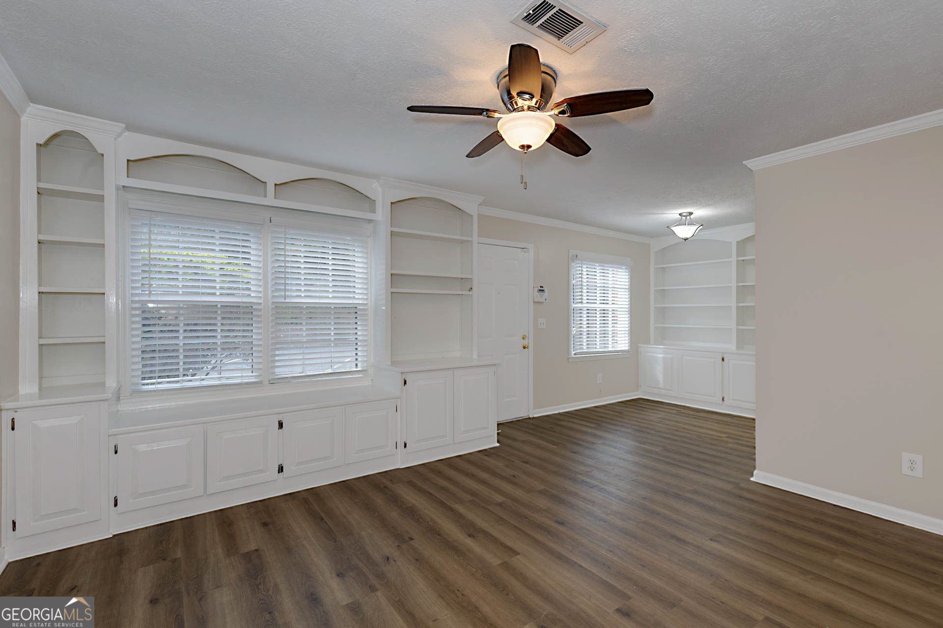 6101 River Road, Unit 2 Columbus, GA 31904 - Photo 3 of 27 an empty room with wooden floor fan and windows