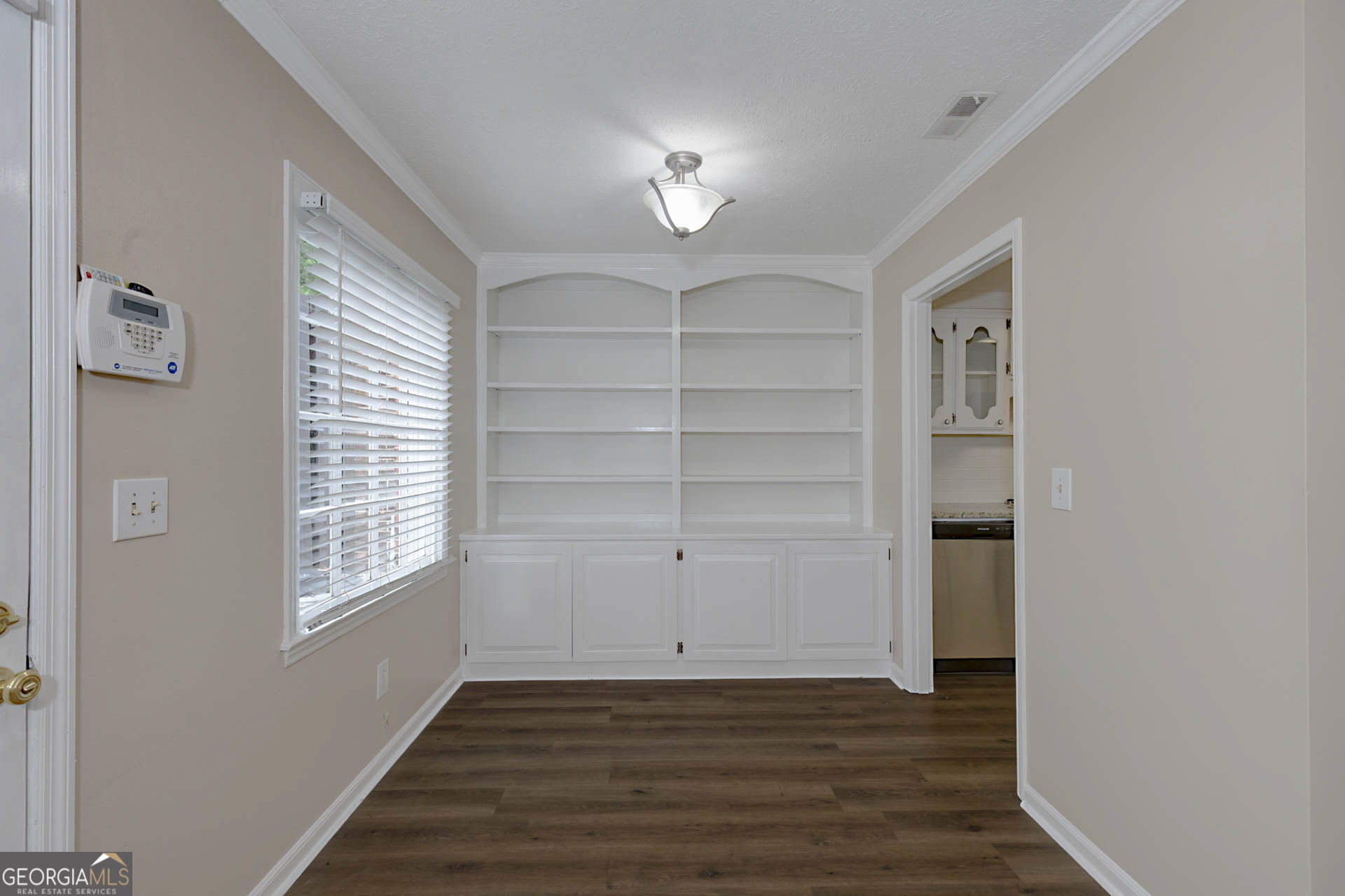 6101 River Road, Unit 2 Columbus, GA 31904 - Photo 4 of 27 a view of an empty room with a window and wooden floor