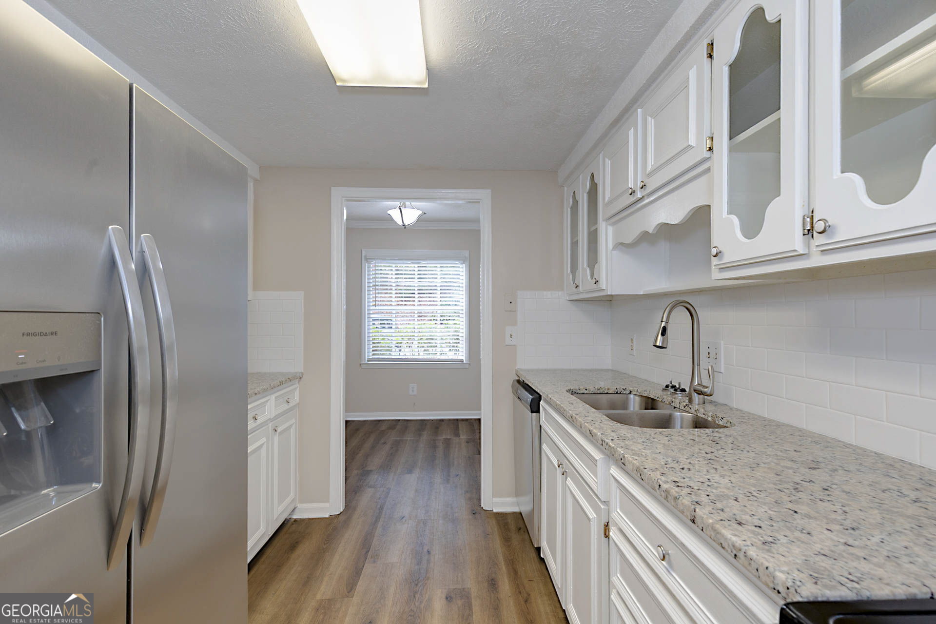 6101 River Road, Unit 2 Columbus, GA 31904 - Photo 6 of 27 a kitchen with stainless steel appliances granite countertop a sink stove and refrigerator