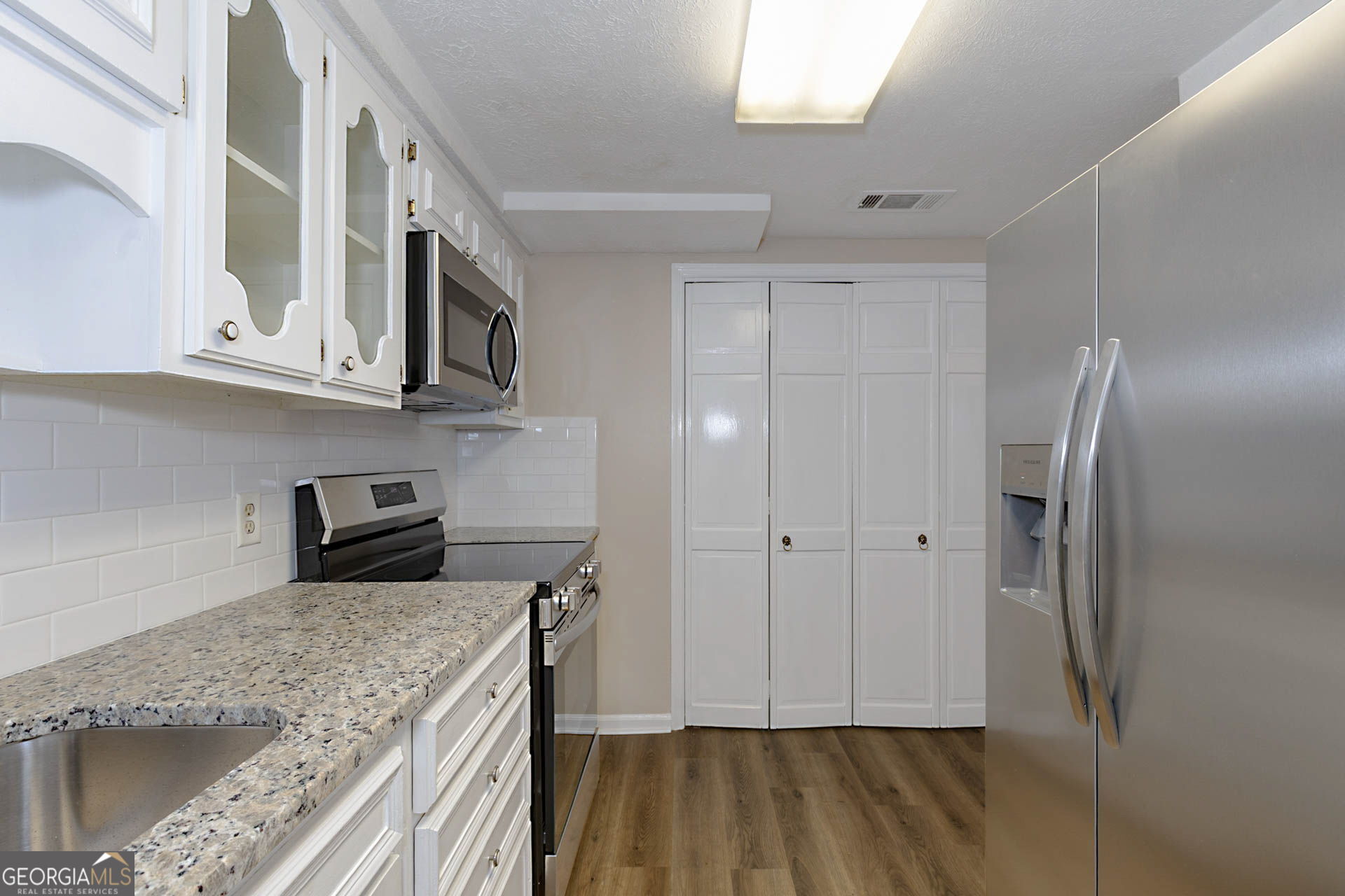 6101 River Road, Unit 2 Columbus, GA 31904 - Photo 7 of 27 a kitchen with cabinets and stainless steel appliances
