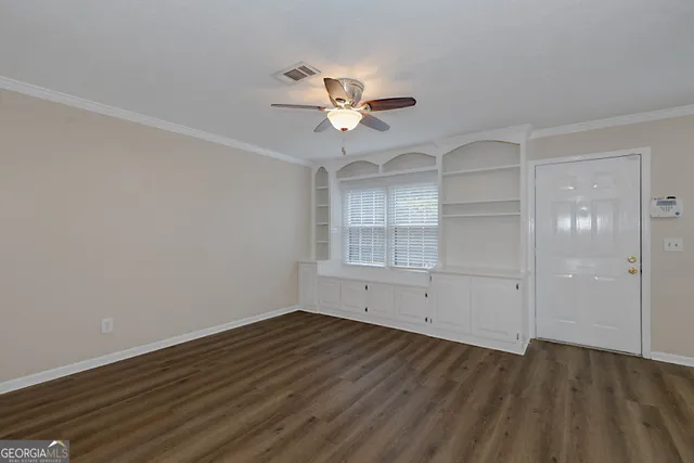 wooden floor in an empty room with a window