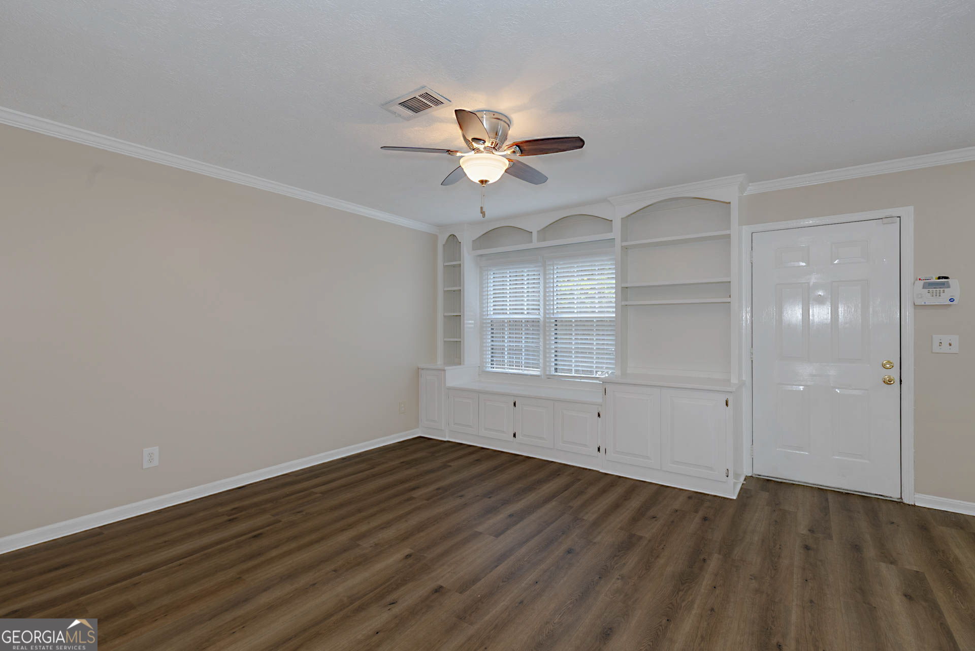 6101 River Road, Unit 2 Columbus, GA 31904 - Photo 9 of 27 wooden floor in an empty room with a window