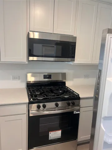 a stove top oven sitting inside of a kitchen