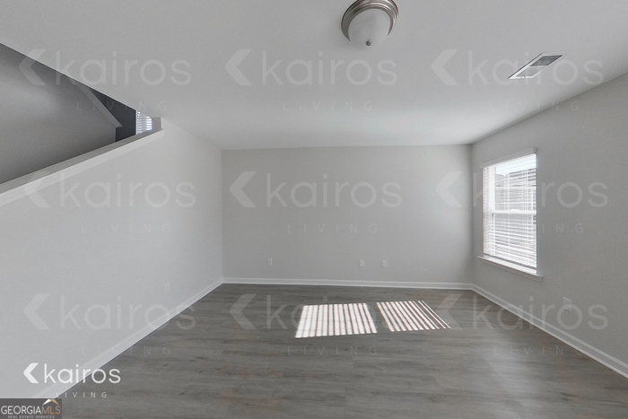 18 Duluth Drive Brunswick, GA 31525 - Photo 11 of 26 a view of an empty room with wooden floor and a window