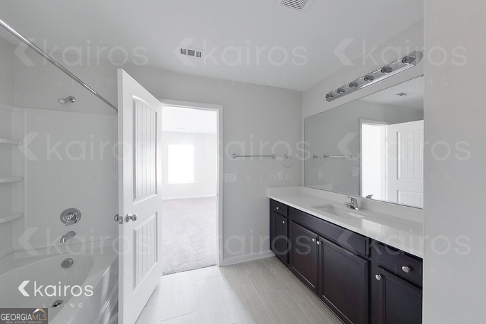 18 Duluth Drive Brunswick, GA 31525 - Photo 17 of 26 a spacious bathroom with a granite countertop sink mirror and double