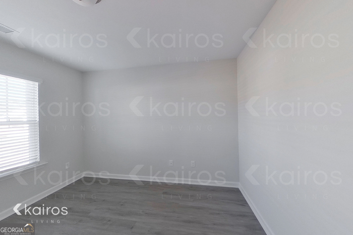 18 Duluth Drive Brunswick, GA 31525 - Photo 2 of 26 a view of an empty room with wooden floor and a window