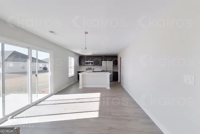 a view of kitchen with sink and refrigerator