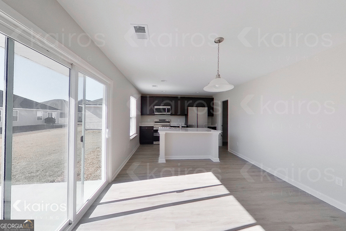 18 Duluth Drive Brunswick, GA 31525 - Photo 6 of 26 a view of a kitchen with kitchen island a sink stainless steel appliances and a large window