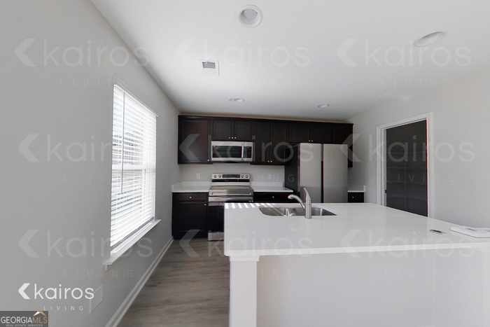18 Duluth Drive Brunswick, GA 31525 - Photo 7 of 26 a kitchen with stainless steel appliances a refrigerator a sink a stove a microwave and cabinets