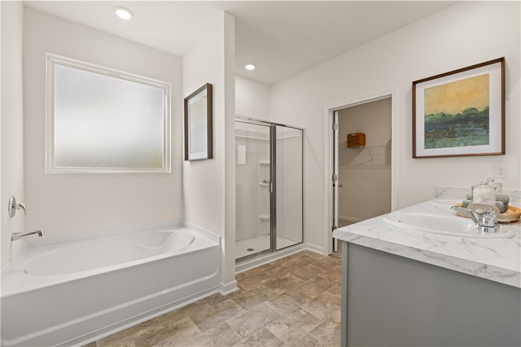 1171 Amerson Street Buckhead, GA 30625 - Photo 27 of 51 a bathroom with a tub a sink and mirror
