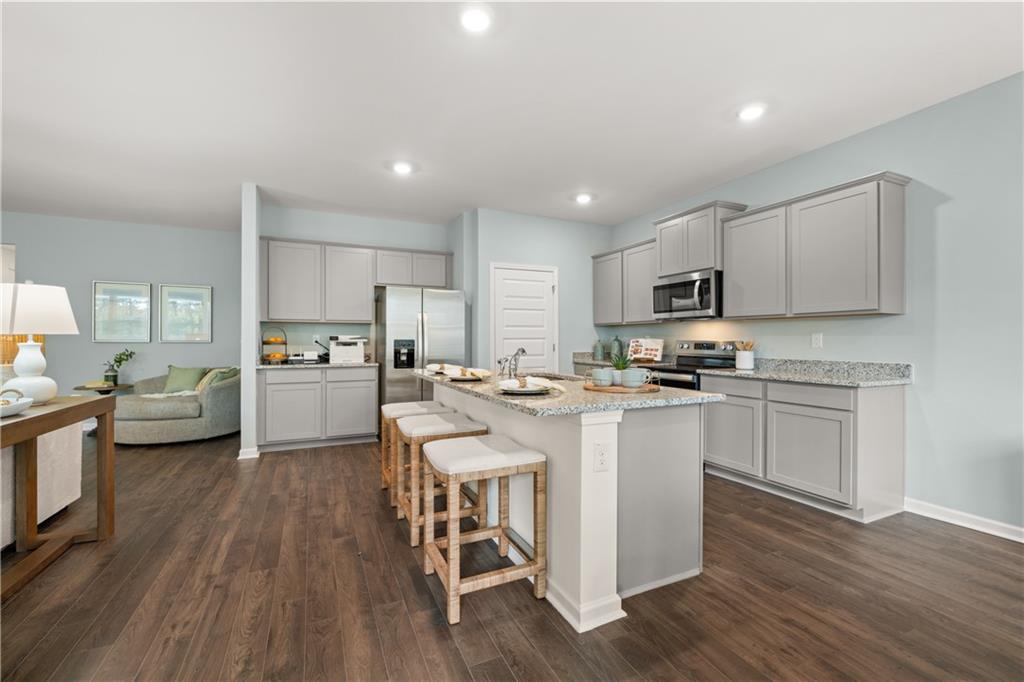 1171 Amerson Street Buckhead, GA 30625 - Photo 6 of 51 a kitchen with a sink a counter top space stainless steel appliances and cabinets