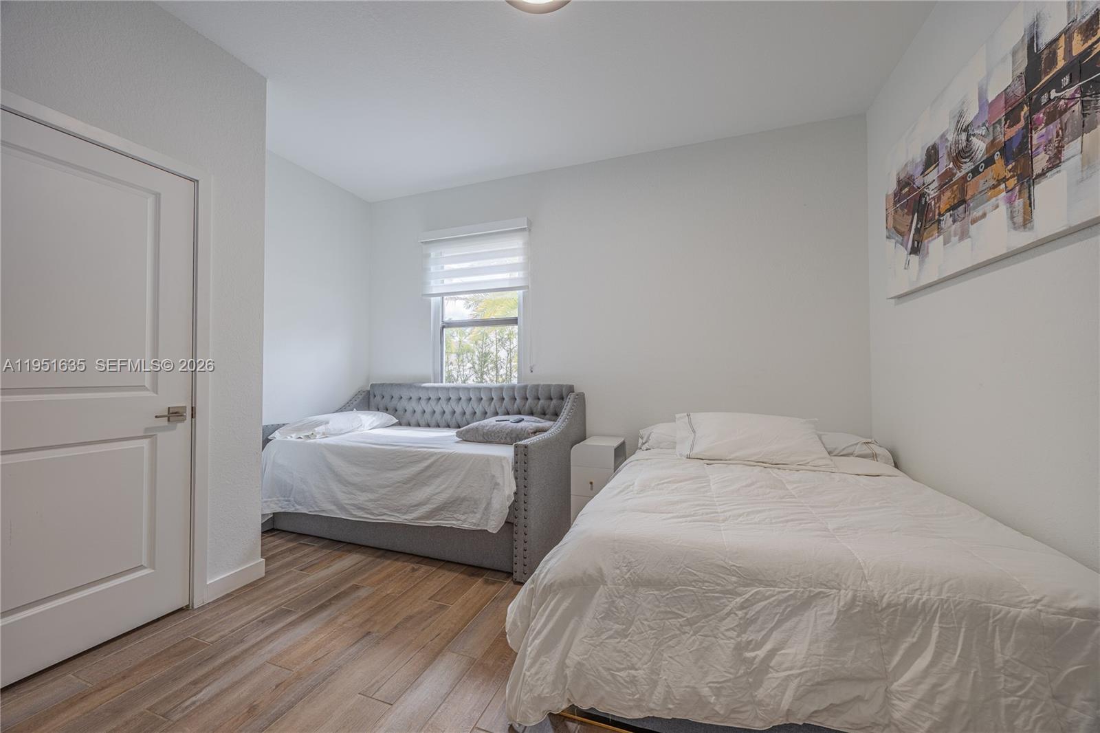 7126 Rockwood Road Jupiter, FL 33458 - Photo 11 of 30 a bedroom with two beds and a window