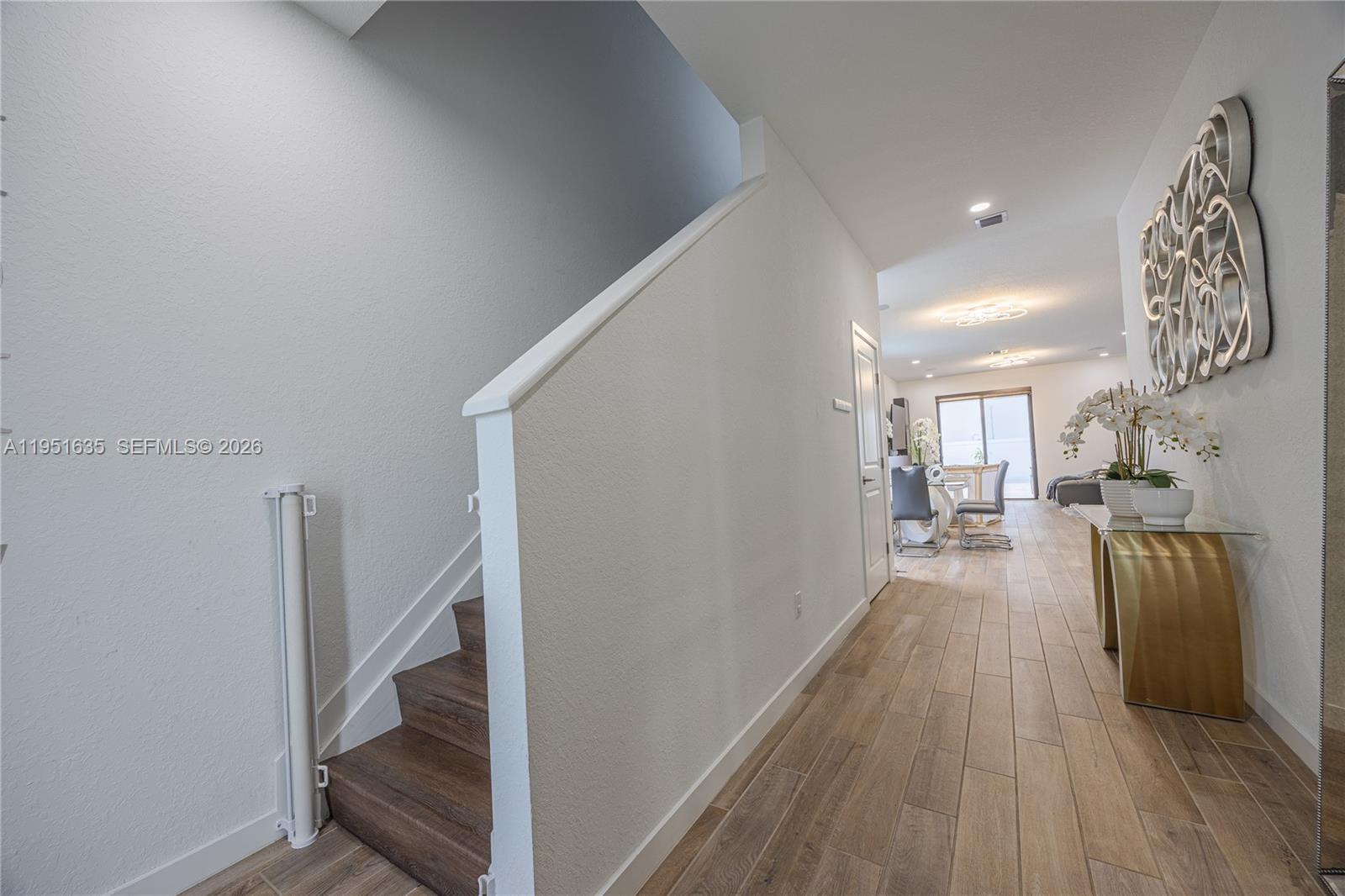 7126 Rockwood Road Jupiter, FL 33458 - Photo 21 of 30 a view of a hallway with wooden floor and staircase