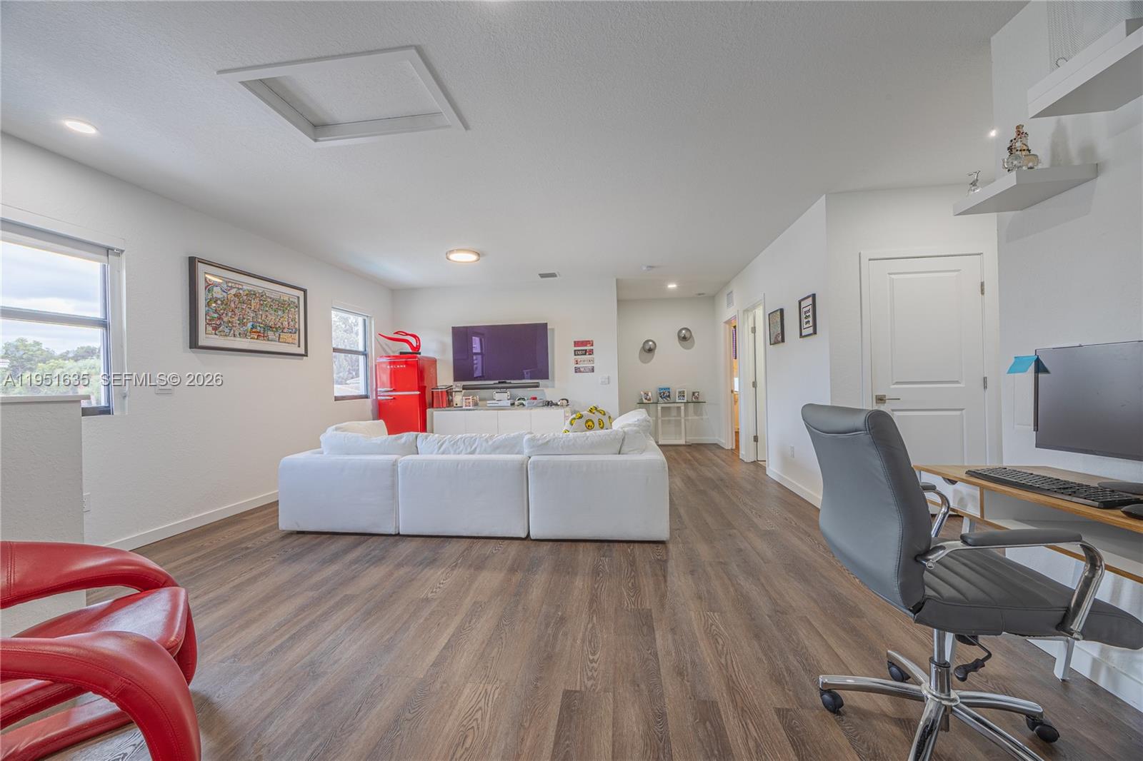 7126 Rockwood Road Jupiter, FL 33458 - Photo 22 of 30 a living room with furniture and a wooden floor