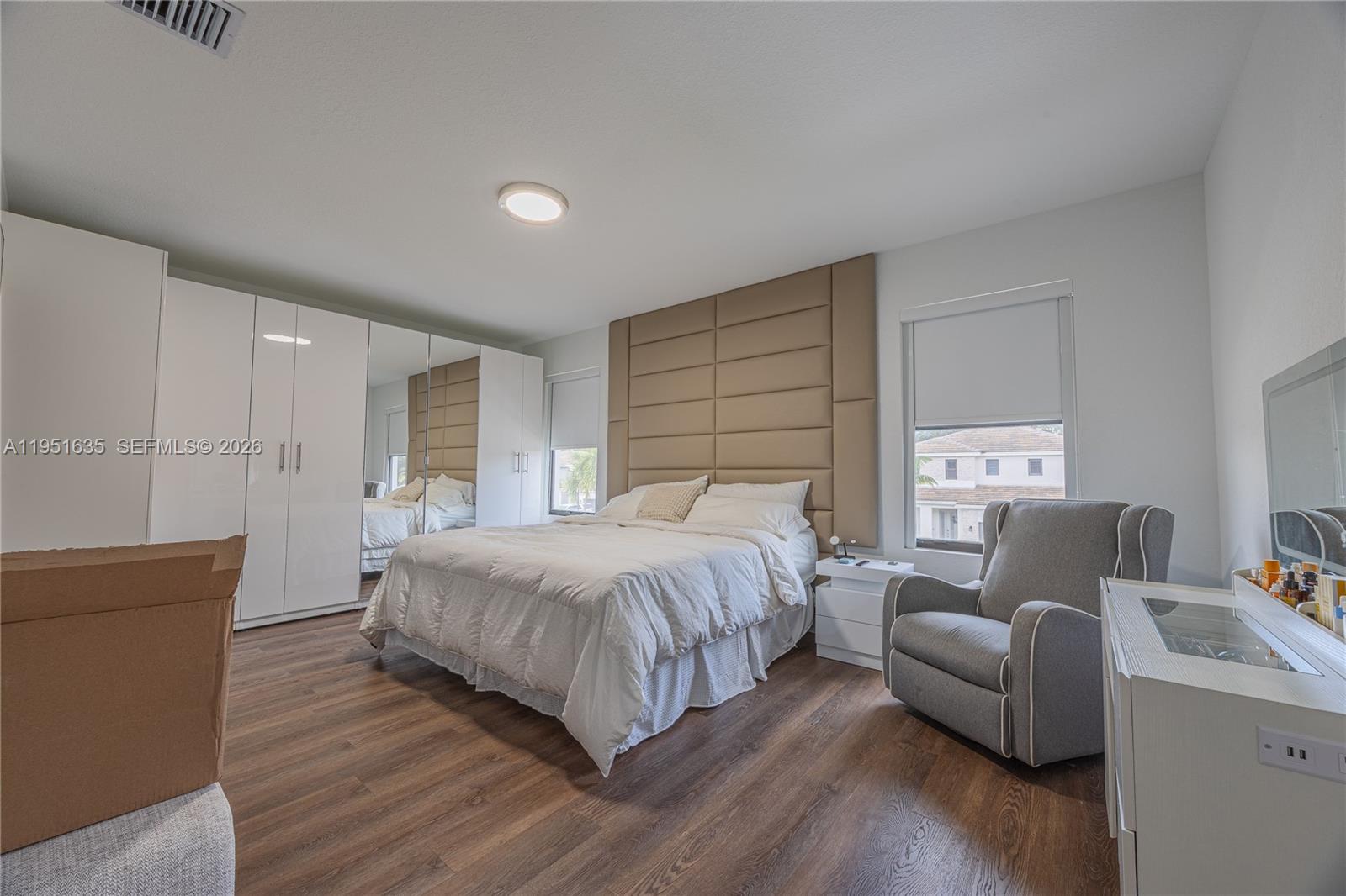 7126 Rockwood Road Jupiter, FL 33458 - Photo 28 of 30 a bedroom with a bed and a couch