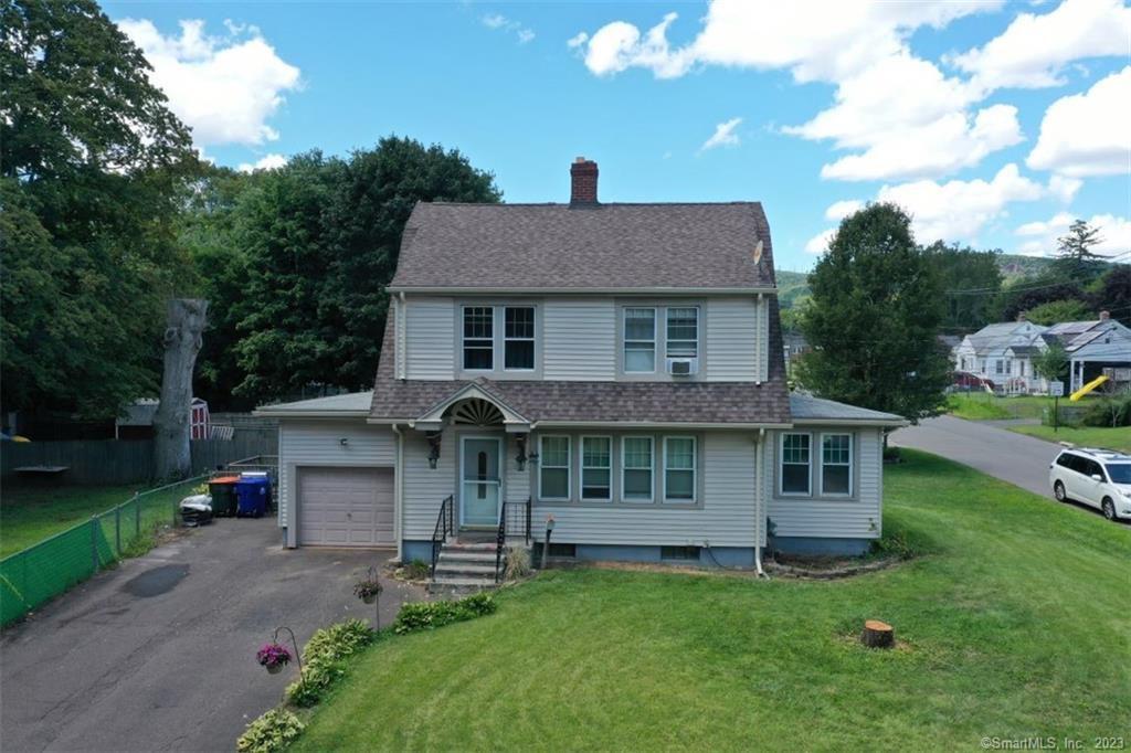 a view of a house with a yard