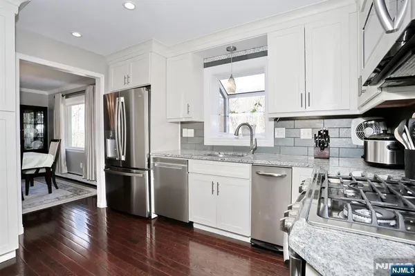 a kitchen with a sink stove and refrigerator