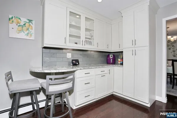 a kitchen with stainless steel appliances cabinets and a window
