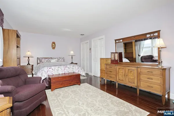 a bedroom with furniture and a dresser