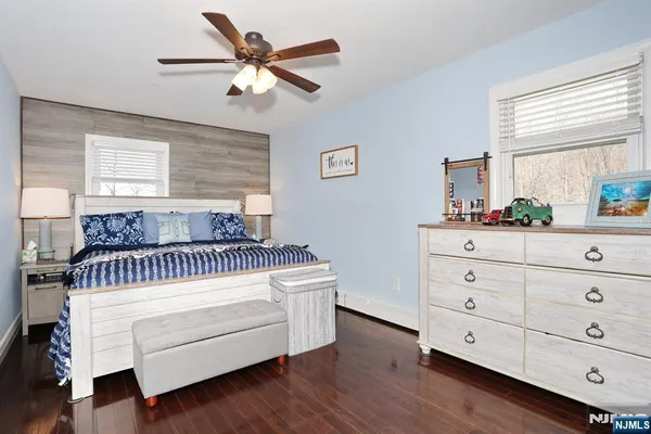 a bedroom with a bed and a dresser in it