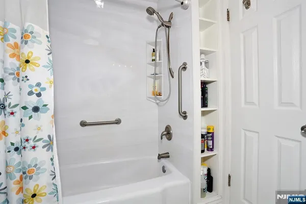 a bathroom with a bathtub and shower