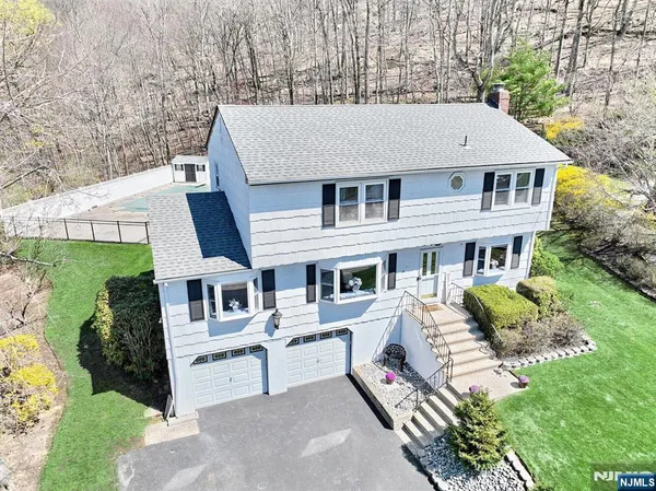 a view of a house with a yard and sitting area