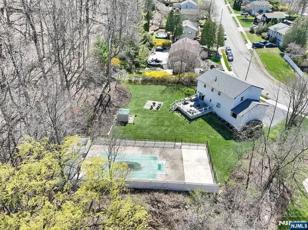an aerial view of a house with swimming pool and outdoor space