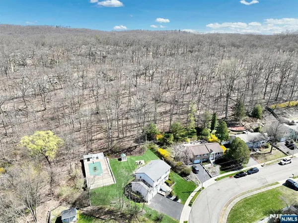 a front view of a house with a garden and plants