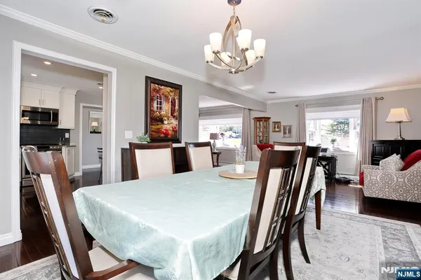 a view of a dining room with furniture and chandelier