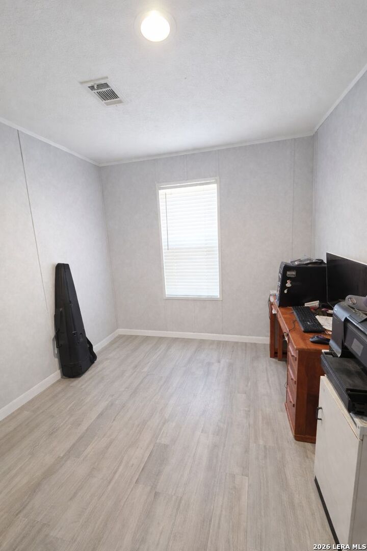 721 Tejas Trail Bandera, TX 78003 - Photo 13 of 17 a view of a workspace with furniture and a window