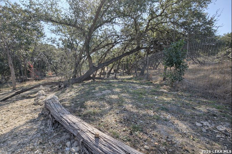 721 Tejas Trail Bandera, TX 78003 - Photo 17 of 17 a view of a yard with wooden fence