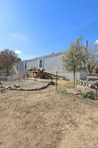 a backyard of a house with large trees