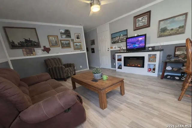 a living room with furniture a flat screen tv and a fireplace